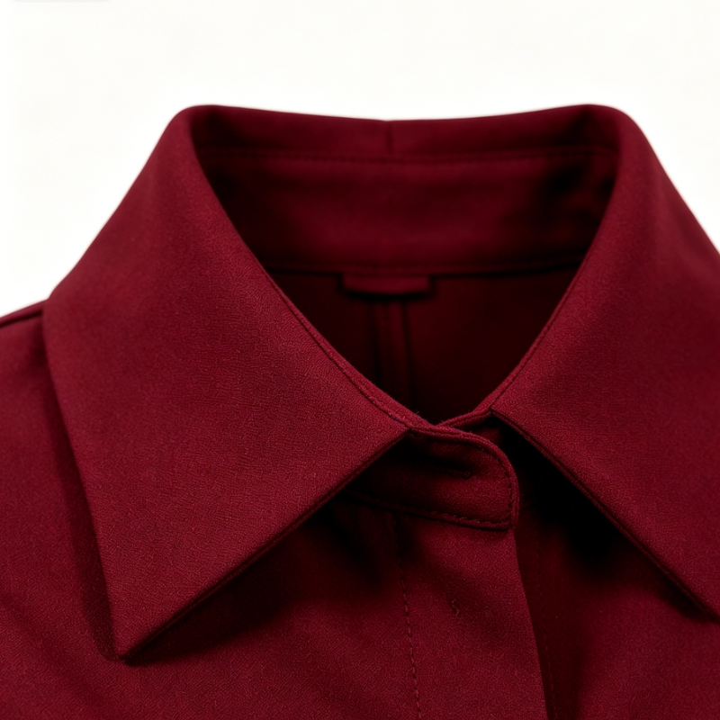 Sophisticated burgundy shirt-collar dress with a fitted waist and ruffled hem
